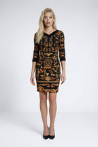 Woman wearing a patterned dress on a white background