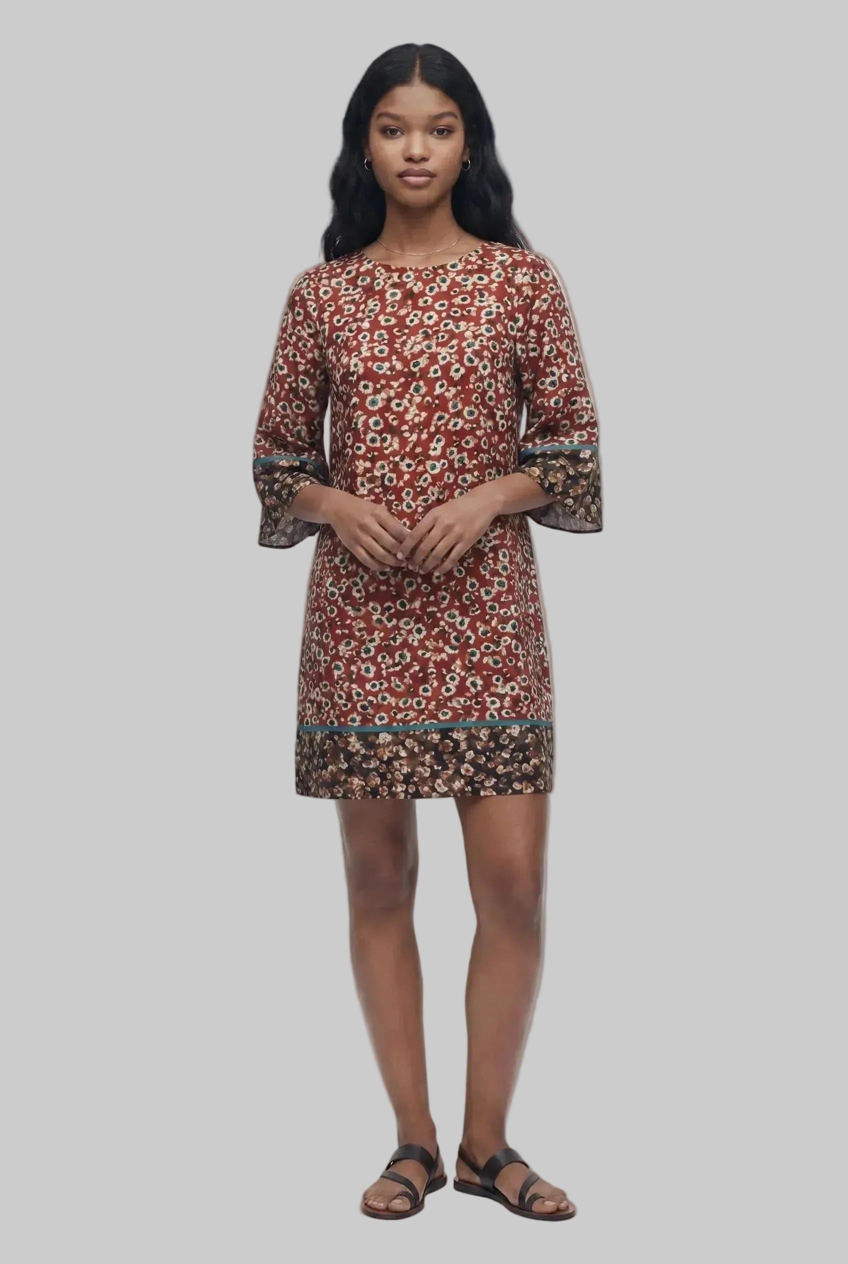 Woman wearing a patterned dress on a white background