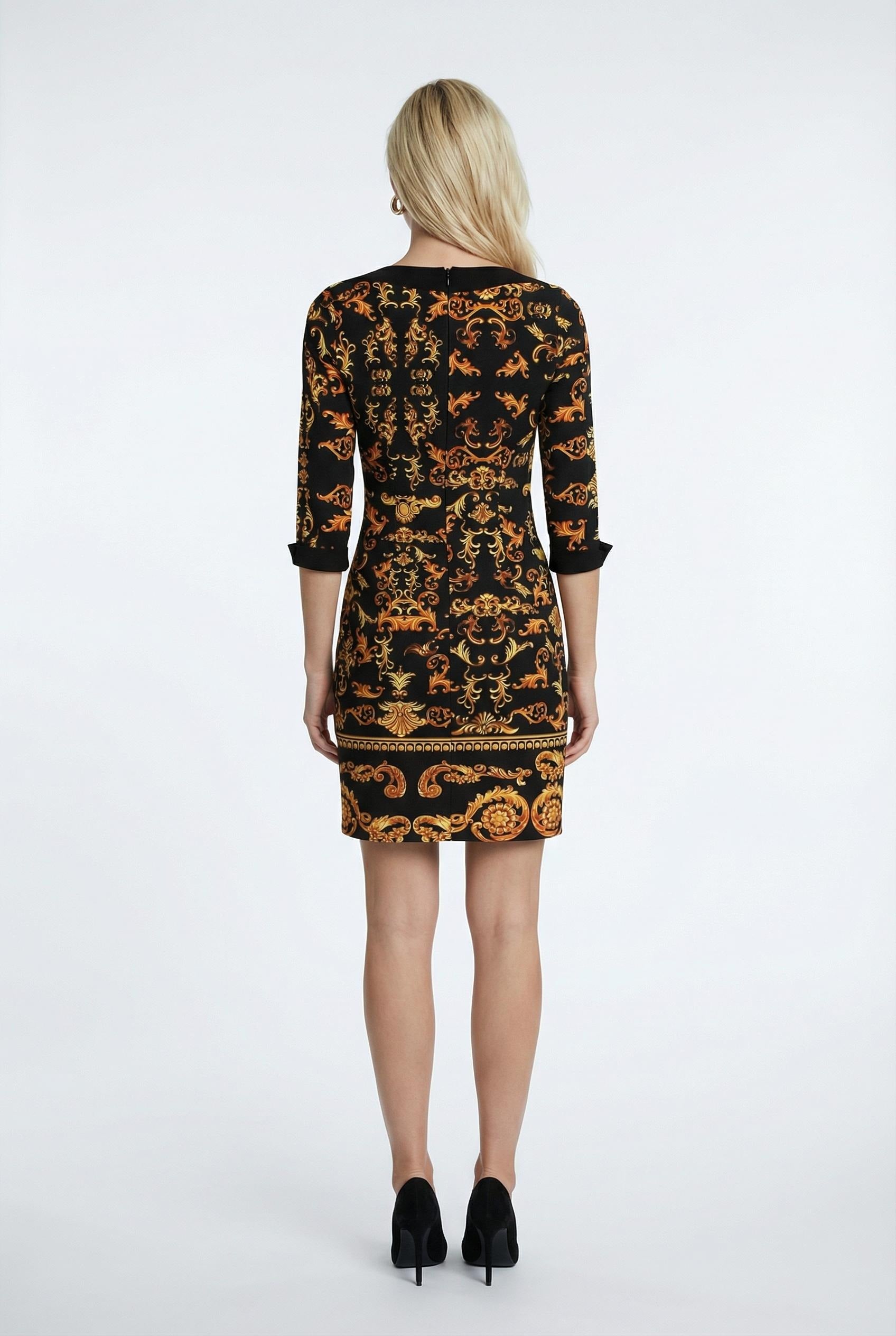 Woman wearing a black and orange patterned dress on a white background